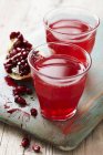 Pomegranate juice in glasses — Stock Photo
