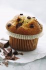 Chocolate chip muffin on white paper — Stock Photo