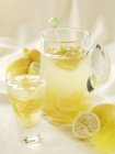 Homemade lemonade in jug and glass — Stock Photo