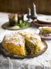 Closeup view of cut Pastilla with pistachios and icing sugar — Stock Photo