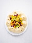 Pavlova with fresh fruits on white plate — Stock Photo
