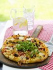 Rustic pizza with rocket — Stock Photo