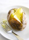 Jacket potato with butter — Stock Photo