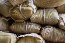 Closeup view of Mexican Tamales corn parcels — Stock Photo
