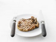 Grilled pork chop on plate — Stock Photo