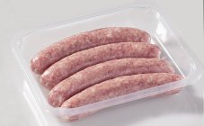 Sausages in plastic container — Stock Photo