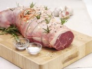 Seasoned raw leg of lamb with rosemary — Stock Photo