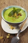 Pea soup with croutons and mint — Stock Photo