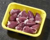 Raw Turkey hearts in plastic container — Stock Photo