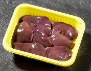 Raw Turkey livers in plastic container — Stock Photo