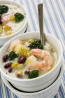 Bowls of Cajun Shrimp, Corn and Bean Bisque over tablecloth — Stock Photo