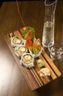 Lobster sushi on wooden platter — Stock Photo