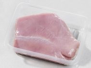 Fresh turkey fillet in plastic container — Stock Photo