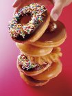 Stacked Doughnuts on red — Stock Photo