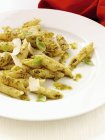 Penne pasta with pesto and parmesan — Stock Photo