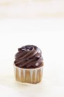 Cupcake au glaçage au chocolat et saupoudrer — Photo de stock