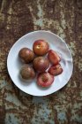 Fresh plums with slices — Stock Photo