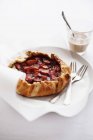 Closeup view of strawberry galette with glass of coffee — Stock Photo