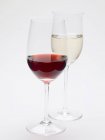 Glasses of red wine and white wine — Stock Photo