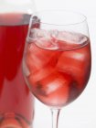 Glass of rose wine with ice cubes — Stock Photo