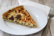 Closeup view of olive Quiche slice on white plate — Stock Photo