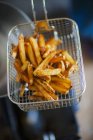 French fries in frying basket — Stock Photo