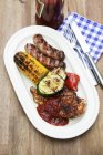Barbecued food on platter — Stock Photo
