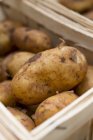 Potatoes in woodchip basket — Stock Photo