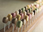 Lots of macaroons on sticks — Stock Photo