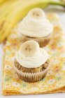 Bananen-Cupcakes auf floralem Tuch — Stockfoto