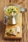 Hummus with coriander and pita bread  over wooden desk — Stock Photo