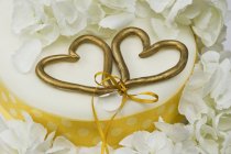 Wedding cake with two love hearts — Stock Photo