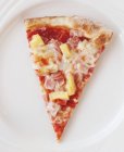 Slice of pizza with ham and pineapple — Stock Photo