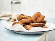 Closeup view of Churros dusted with icing sugar — Stock Photo