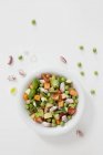 A white bowl of soup vegetables over white surface — Stock Photo