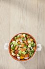 A bowl of soup vegetables over wooden surface — Stock Photo
