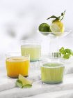 Closeup view of various lemonades with apricot, basil and ginger — Stock Photo