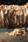 Closeup view of chicken shawarma grilling block — Stock Photo