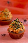 Chocolate cupcakes with orange buttercream — Stock Photo
