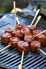 Sausage snails on skewers — Stock Photo
