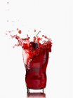 Splashing glass of cherry juice — стоковое фото