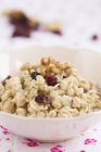 Bowl of oats with nuts — Stock Photo