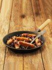 Sausages with red onions and thyme — Stock Photo