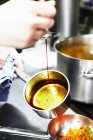 Cropped view of person caramelizing sugar in a pot — Stock Photo