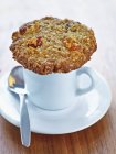 Raisin cookie on top of white cup — Stock Photo