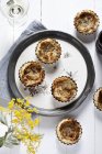 Onion tartlets on plate — Stock Photo