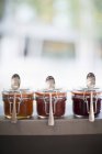 Jars of fruit jams with spoons — Stock Photo