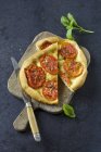 Top view of Tomato Focaccia on chopping board with knife — Stock Photo