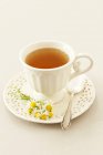 Cup of camomile tea — Stock Photo