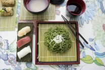 Nigiri sushi with wasabi noodles — Stock Photo